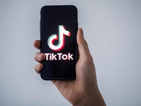 In this file photo taken Jan. 21, 2021 in Nantes, France, a man shows a smartphone with the logo of TikTok.