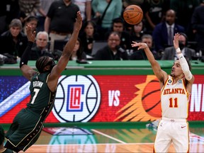 Trae Young of the Atlanta Hawks shoots the game winning 29-foot three point basket against Jaylen Brown of the Boston Celtics during the fourth quarter in Game 5 of the Eastern Conference First Round Playoffs at TD Garden on April 25, 2023 in Boston, Mass.