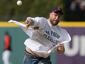 Chiefs player Travis Kelce throws out the first pitch before the game between the Guardians and Mariners at Progressive Field in Cleveland, Friday, Apr. 7, 2023.