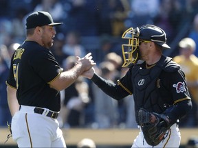 Pittsburgh Pirates relief pitcher David Bednar, left, and catcher Tyler Heineman celebrate after defeating the Chicago White Sox at PNC Park in Pittsburgh, Pa., April 9, 2023.