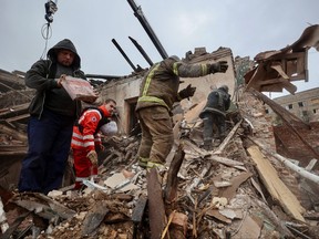 Rescuers and volunteers work at the site of a building of local museum heavily damaged by a Russian missile strike, amid Russia's attack on Ukraine, in the town of Kupiansk, Kharkiv region, Ukraine April 25, 2023.