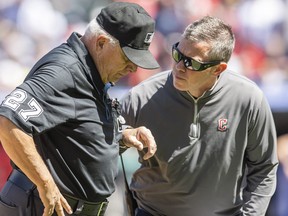 Cleveland Guardians trainer James Quinlan, right, looks at umpire Larry Vanover after Vanover was hit with the baseball during a play in the fifth inning of the game between the Guardians and the New York Yankees at Progressive Field.