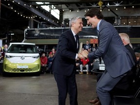 Prime Minister Justin Trudeau and Minister of Innovation, Science and Industry Francois-Philippe Champagne react during a news conference to announce details on the construction of a gigafactory for electric vehicle battery production by Volkswagen Group's battery company PowerCo SE in St. Thomas, Ont., April 21, 2023.