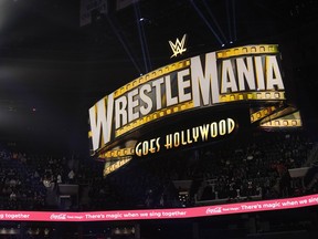 A WrestleMania sign hangs over the crowd Monday, March 6, 2023, in Boston.