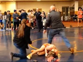 A screenshot of a youth wrestler on the ground, who was sucker punched following a match. YouTube/@wrestlingspot