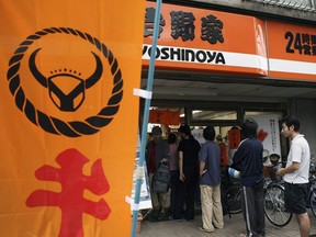 Diners line up to eat the beef bowl dish "Gyudon" at one of the major beef bowl restaurant chains on September 18, 2006 in Tokyo, Japan.