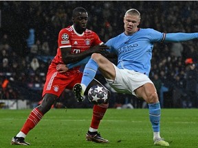 Munich’s French defender Dayot Upamecano (L) vies with Manchester City’s Norwegian striker Erling Haaland (R) during the UEFA Champions League quarter final, first leg football match between Manchester City and Bayern Munich at the Etihad Stadium in Manchester, north-west England, on April 11, 2023. (Paul ELLIS / AFP)