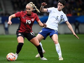 France's defender Elisa De Almeida (R) fights for the ball with Canada's forward Adriana Leon (L) during the women's international friendly football match between France and Canada at the Marie Marvingt Stadium, in Le Mans, northwestern France, on April 11, 2023.