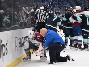 Colorado Avalanche head athletic trainer Matt Sokolowski tends to centre Andrew Cogliano  during the second period against the Seattle Kraken in Game 6 of the first round of the 2023 Stanely Cup Playoffs at Climate Pledge Arena in Seattle, Wash., April 28, 2023.