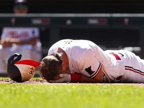 Apr 12, 2023; Minneapolis, Minnesota, USA; Minnesota Twins second baseman Kyle Farmer (12) drops to the ground after getting hit by a pitch in the face by the Chicago White Sox in the fourth inning at Target Field.
