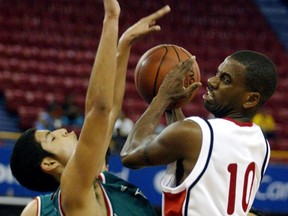 Greg Francis, right, of Toronto drives through P. Mesa of Mexico during basketball action at the Pan Am Games in Santo Domingo, Dominican Republic on Monday August 4, 2003. Former Canadian men's basketball national team member and Olympian Francis has died at the age of 48.