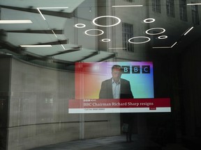 A screen showing a news report through the windows of the BBC, after chairman Richard Sharp announced he was quitting as BBC chairman, in London, Friday April 28, 2023.