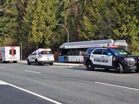 Police officers and paramedics attend the scene of a stabbing on board a transit bus in Surrey, B.C. on Saturday, April 1, 2023.