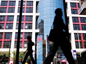 Pedestrians walk in front of the Canadian Broadcasting Corporation (CBC) building in downtown Toronto on June 7, 2006.