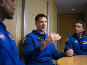 Canadian Space Agency astronaut Jeremy Hansen, centre, participates in interviews with fellow members of the Artemis II crew, NASA astronauts Victor Glover, left, Reid Wiseman, right, and Christina Hammock Koch, not shown, at the U.S. Embassy in Ottawa, Tuesday, April 25, 2023.