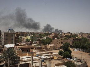 Smoke is seen in Khartoum, Sudan, Saturday, April 22, 2023. Ottawa says it's working on ways to try evacuating Canadians out of Sudan, and is asking them to register with Global Affairs Canada.