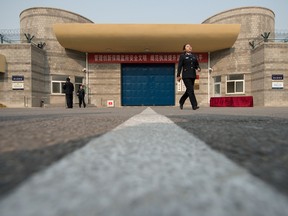 A guard walks outside the main entrance to the No.1 Detention Center during a government guided tour in Beijing on October 25, 2012.