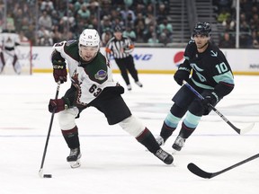 Coyotes left wing Matias Maccelli (left) carries the puck as Kraken centre Matty Beniers (right) defends during first period NHL action in Seattle, Monday, April 3, 2023.