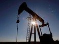 The sun is seen behind a crude oil pump jack in the Permian Basin in Loving County, Texas, Nov. 22, 2019.