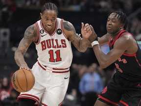 Chicago Bulls' DeMar DeRozan (left) moves up court as Raptors' O.G. Anunoby defends during the first half in Toronto on Wednesday, April 12, 2023.