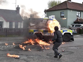 A police vehicle is attacked with petrol bombs ahead of a Republican parade on April 10, 2023 in Derry, Northern Ireland.
