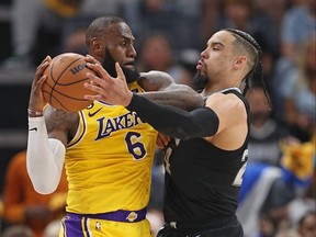 LeBron James of the Los Angeles Lakers handles the ball against Dillon Brooks of the Memphis Grizzlies.