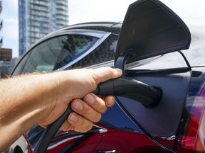 An electric vehicle is charged in Ottawa on Wednesday, July 13, 2022.&ampnbsp;Electric vehicle drivers can expect more charging options ahead as the Canada Infrastrcture Bank is loaning $220 million to Flo Services Inc. to expand its network.
