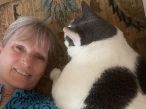 Ford and Patches cuddling on the floor. Ford hopes to embark on her own weight loss journey alongside her cat. (Kay Ford photo)