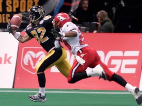 Darren Flutie of the Hamilton Tiger-Cats reels in a pass one-handed for a touchdown as he is chased by Shadwick Criss of the Calgary Stampeders during second quarter action at the Grey Cup in Vancouver, Sunday, Nov. 28, 1999. CFL Hall of Fame receiver Darren Flutie will be inducted to the Hamilton Tiger-Cats Wall of Honour at Tim Hortons Field in Hamilton on Aug. 17, the team announced Thursday.