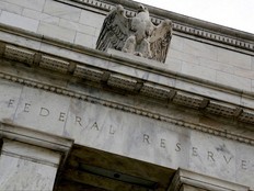 An eagle tops the U.S. Federal Reserve building's facade in Washington, July 31, 2013.