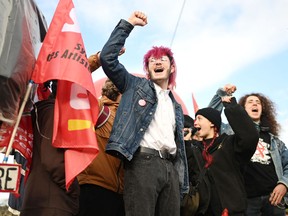 Young protesters raise their fist and shout slogans during a demonstration on the day of a ruling from France's Constitutional Council on a contested pension reform pushed by the French government, in Nantes, France, on April 14, 2023.