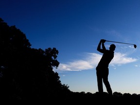 A golfer is silhouetted in Oakville, Ont., on Friday, July 26, 2013. The PGA Tour is merging two of its third-tier circuits. PGA Tour Canada and PGA Tour Latinoamérica will combine to become the PGA Tour Americas in February.