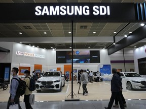 People walk by Samsung SDI Co.' booth during the InterBattery 2021, the country's leading battery exhibition, at COEX in Seoul, South Korea, on June 9, 2021.