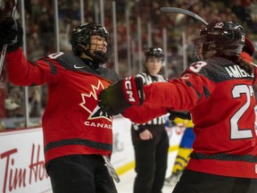 Team Canada forward Sarah Nurse (left) is congratulated by defender Erin Ambrose (right) after scoring on Sweden during second period quarterfinal IIHF Women's World Hockey Championship hockey action in Brampton, Ont., Thursday, April 13, 2023.