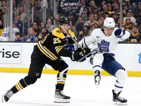 Brandon Carlo of the Boston Bruins and William Nylander of the Toronto Maple Leafs battle for control of the puck at TD Garden on April 6, 2023 in Boston.