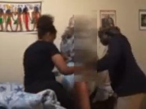 Screenshot from livestream of two women abusing elderly woman.