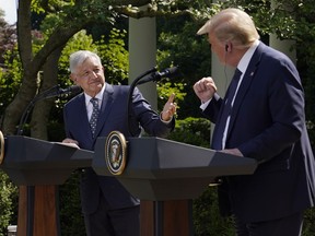 FILE - President Donald Trump, right, and Mexican President Andres Manuel Lopez Obrador gesture before signing a joint declaration at the White House in Washington, July 8, 2020. Mexico's president said on April 5, 2023 that he opposes the criminal charges filed against Trump, suggesting they were brought for political reasons during an electoral campaign.