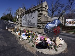 A balloon with names of the victims is seen at a memorial at the entrance to The Covenant School on Wednesday, March 29, 2023, in Nashville, Tenn.