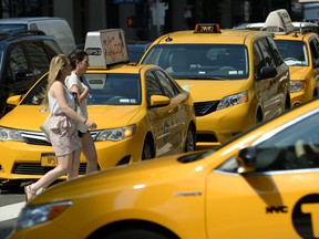 Taxis  come down 2nd Avenue in New York  on July 10, 2014.