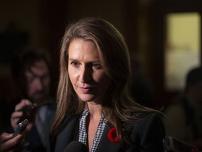 Ontario Transportation Minister Caroline Mulroney, scrums with the media in the Ontario legislature in Toronto, on Monday, October 28, 2019. Mulroney is defending delays in opening a midtown Toronto light rail transit line, saying Ottawa's LRT is an example of what happens when a transit system starts operating before it is ready.