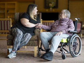Sheri Levergood spends time with her mother, Janet Levergood at a long-term care residence where Janet now lives in Waterloo, Ont. on Tuesday, April 4, 2023. The government's new law, Bill 7, is affecting those in hospital by threatening to send them to a nursing home not of their choosing.