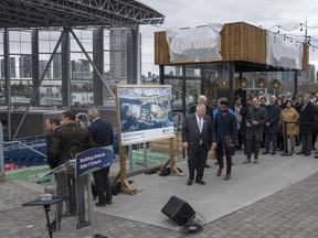 Ontario Premier Doug Ford stands next to an illustrated development plan before at Ontario Place in Toronto on Tuesday, April 18, 2023.