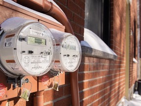 Electricity meters are shown on the side of homes.
