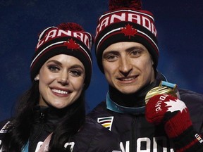 Gold medallists in the ice dance, free dance figure skating Tessa Virtue and Scott Moir, of Canada, pose during their medals ceremony at the 2018 Winter Olympics in Pyeongchang, South Korea, Tuesday, Feb. 20, 2018.