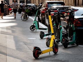 In this file photo, free floating rental electric scooters are seen on a sidewalk in Paris.