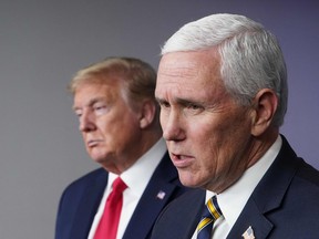 In this file photo taken on April 22, 2020, U.S. President Donald Trump listens to U.S. Vice-President Mike Pence speak during the the daily briefing on the novel coronavirus, which causes COVID-19, in the Brady Briefing Room of the White House in Washington, D.C.