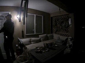 In this image taken from body camera video provided by the Farmington Police Department, a police officer knocks on the door of the wrong address in response to a domestic violence call, in Farmington, N.M., late April 5, 2023.