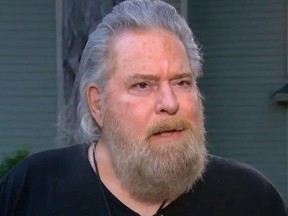 Man with grey hair and grey beard.