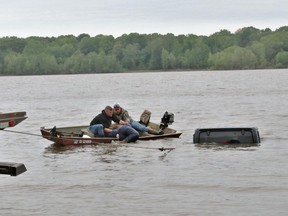 Police rescue a woman from a vehicle in Lake O’ the Pines, in Texas.