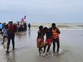 In this photo released by the People Unity Foundation, rescuers from the charitable organization help a survivor from a boat that capsized off the coast of Nakhon Sri Thammarat province, southern Thailand on April 16, 2023.